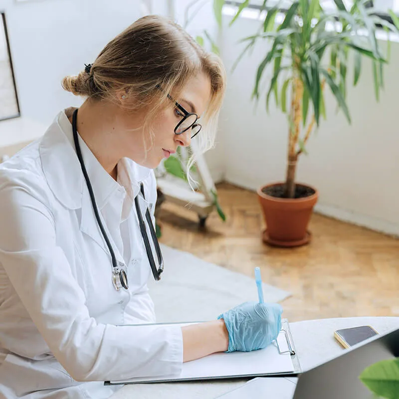 expert-care medical professional looking at lab charts